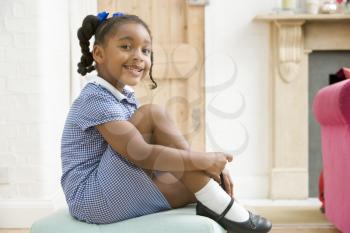 Royalty Free Photo of a Little Girl Buckling Her Shoe