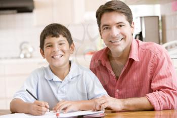 Royalty Free Photo of a Father Helping His Son With Homework