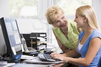 Royalty Free Photo of a Woman and Girl in a Home Office