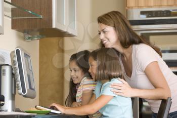 Royalty Free Photo of a Mother With Two Girls at a Laptop