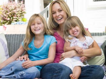 Royalty Free Photo of a Mother and Two Girls Sitting Outside