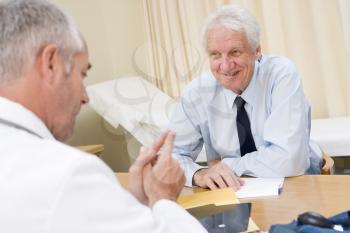 Royalty Free Photo of a Man Smiling in a Doctor's Office