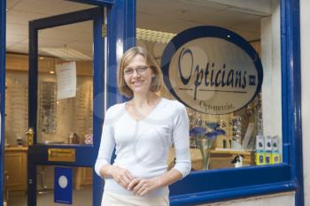 Royalty Free Photo of a Woman Outside an Optometrist's Office