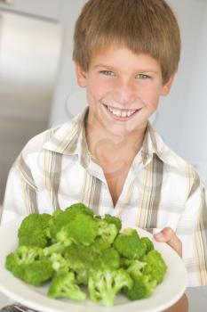 Royalty Free Photo of a Boy With a Plate of Broccoli