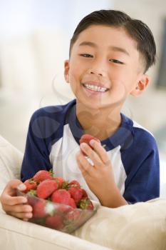 Royalty Free Photo of a Boy Eating Strawberries