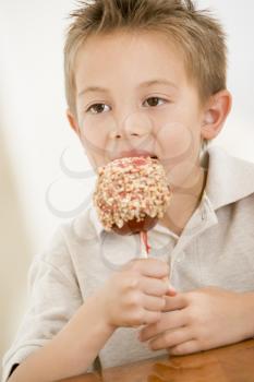 Royalty Free Photo of a Boy Eating Candy