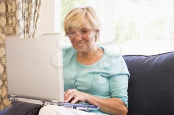 Royalty Free Photo of a Woman in a Living Room With a Laptop