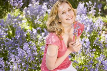 Royalty Free Photo of a Woman Holding Flowers