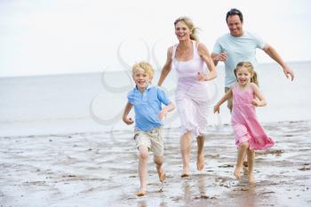 Royalty Free Photo of a Family Running at the Beach