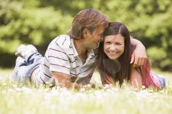 Royalty Free Photo of a Couple Lying in a Field