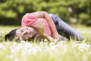 Royalty Free Photo of a Girl Lying in a Field