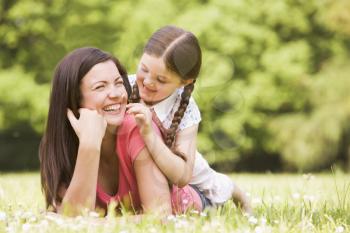 Royalty Free Photo of a Mother and Daughter in the Grass