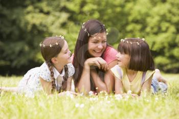 Royalty Free Photo of a Mother and Her Two Daughters Wearing Daisy Chains