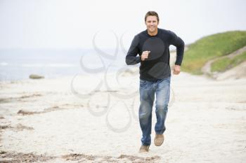 Royalty Free Photo of a Man Running on the Beach