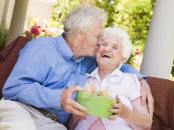 Royalty Free Photo of a Man Giving a Wife a Present