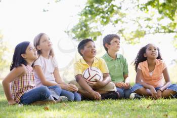 Royalty Free Photo of Five Children With a Soccer Ball Looking Up