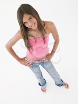 Young girl standing with hands on hips smiling