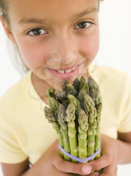 Royalty Free Photo of a Girl Holding Asparagus