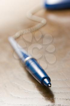 Royalty Free Photo of a Pen Attached to a Cord