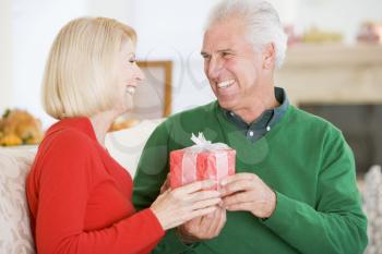 Royalty Free Photo of a Man Giving His Wife a Gift