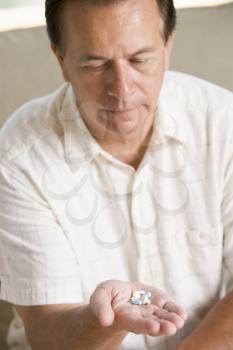 Royalty Free Photo of a Man Taking Pills