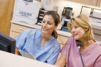 Royalty Free Photo of Nurses in a Hospital Reception Area