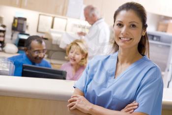 Royalty Free Photo of a Nurse in Front of a Reception Area
