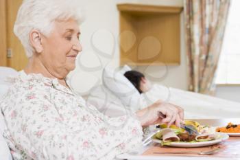 Royalty Free Photo of a Woman Eating in the Hospital