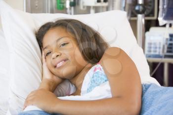 Royalty Free Photo of a Young Girl in a Hospital Bed