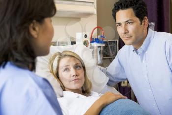 Royalty Free Photo of a Doctor With an Expectant Couple