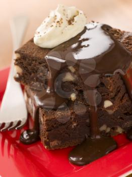 Royalty Free Photo of Brownies With Fudge Sauce and Whipped Cream