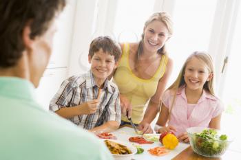 Royalty Free Photo of a Family Preparing a Meal