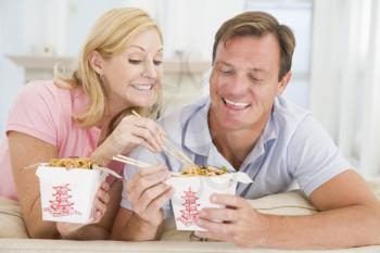 Royalty Free Photo of a Couple Eating Chinese Takeout