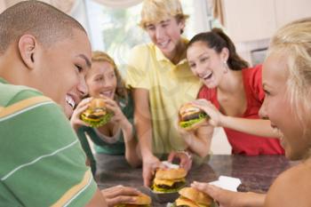 Royalty Free Photo of Teens Eating Burgers