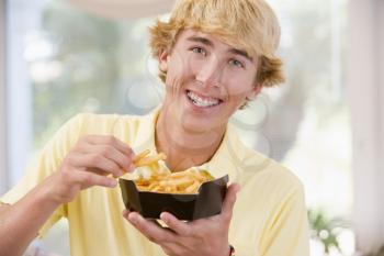 Royalty Free Photo of a Boy Eating French Fries