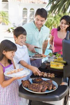 Royalty Free Photo of a Family Barbecuing