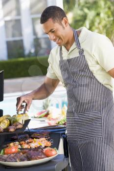 Royalty Free Photo of a Man Barbecuing