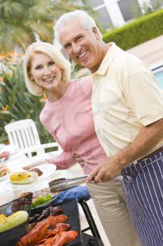 Royalty Free Photo of a Couple Barbecuing