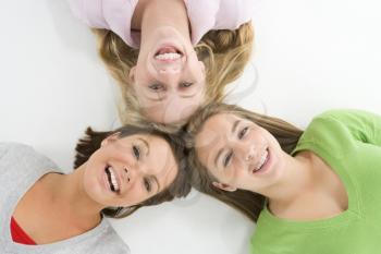 Royalty Free Photo of Three Girls Lying With Their Heads Together