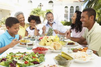 Royalty Free Photo of a Family Eating Outside