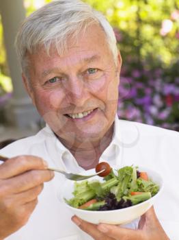 Royalty Free Photo of a Man Eating Salad