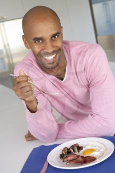 Royalty Free Photo of a Man Having Bacon and Eggs