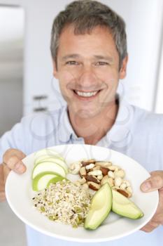 Royalty Free Photo of a Man Holding a Plate of Healthy Food