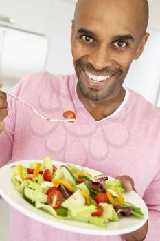 Royalty Free Photo of a Man Eating a Salad