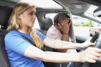 Royalty Free Photo of a Girl Taking a Driving Lesson