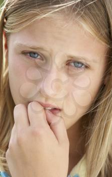 Royalty Free Photo of a Girl Biting Her Nail