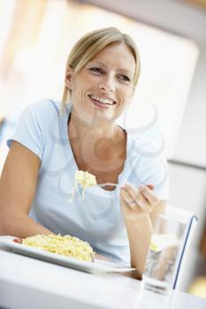 Royalty Free Photo of a Woman Eating Lunch at a Mall