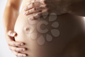 Royalty Free Photo of a Pregnant Woman Holding Her Belly