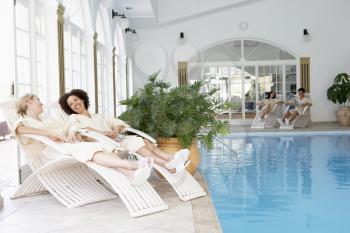 Royalty Free Photo of Women Relaxing at a Pool