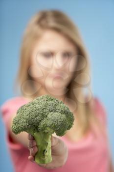 Royalty Free Photo of a Girl Holding Broccoli